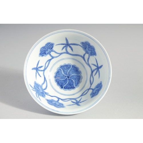 157 - A CHINESE BLUE AND WHITE MING STYLE BOWL, the interior and exterior painted with flower heads, base ... 