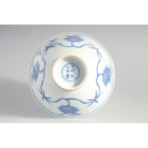 157 - A CHINESE BLUE AND WHITE MING STYLE BOWL, the interior and exterior painted with flower heads, base ... 