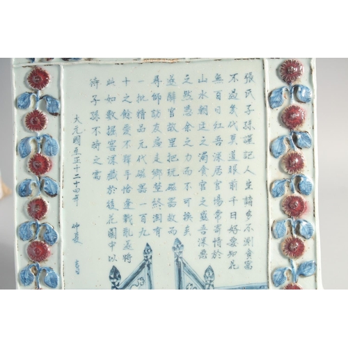 159 - A CHINESE YUAN STYLE BLUE, WHITE AND RED GLAZED POTTERY PLAQUE, with relief decoration and inscripti... 