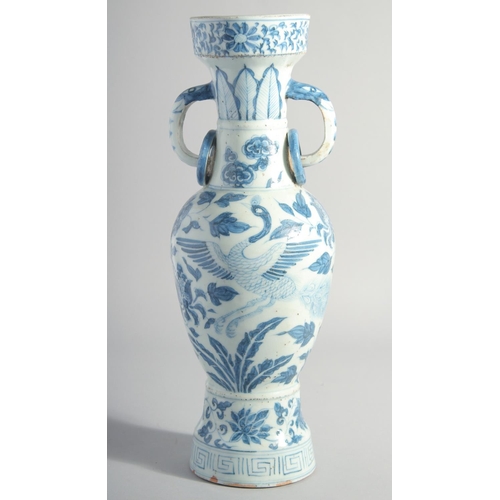 160 - A CHINESE YUAN STYLE BLUE AND WHITE GLAZED POTTERY TWIN HANDLE VASE, painted with birds and flora, 3... 