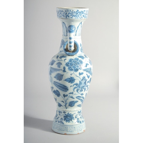 160 - A CHINESE YUAN STYLE BLUE AND WHITE GLAZED POTTERY TWIN HANDLE VASE, painted with birds and flora, 3... 