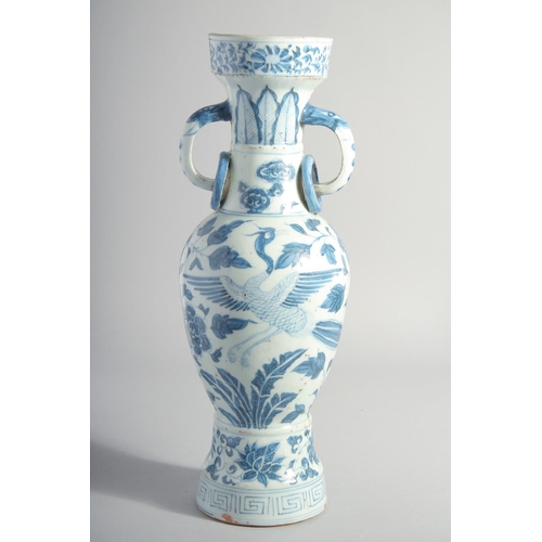 160 - A CHINESE YUAN STYLE BLUE AND WHITE GLAZED POTTERY TWIN HANDLE VASE, painted with birds and flora, 3... 