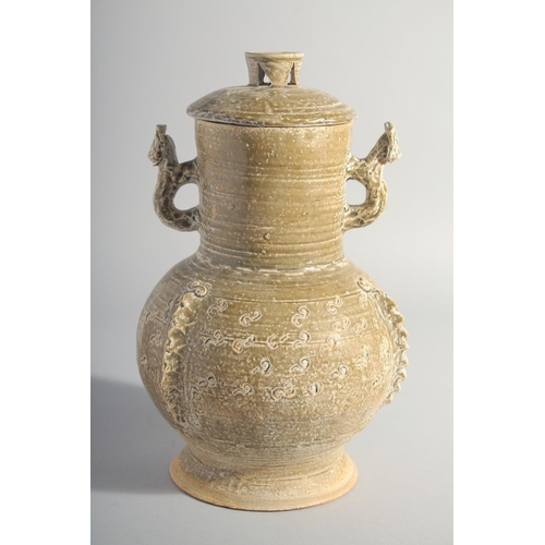 163 - A CHINESE HAN STYLE POTTERY VASE AND COVER, with moulded twin handles, 28.5cm high.