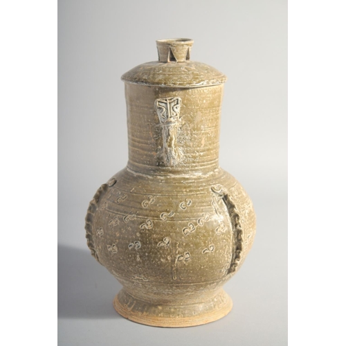 163 - A CHINESE HAN STYLE POTTERY VASE AND COVER, with moulded twin handles, 28.5cm high.