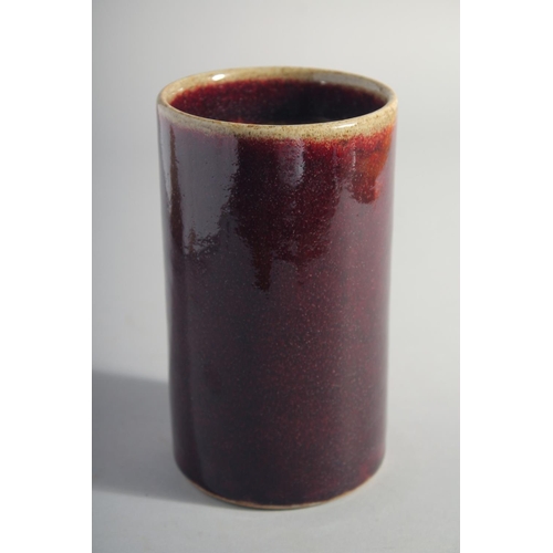 164 - A CHINESE IRON RED GLAZE CYLINDRICAL BRUSH POT, 15cm high.