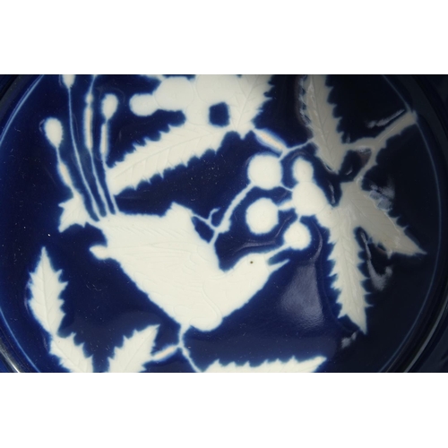 171 - A RARE CHINESE BLUE AND WHITE RESERVE-DECORATED PORCELAIN DISH, the centre with a bird and flora, ba... 