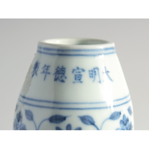 174 - A CHINESE BLUE AND WHITE PORCELAIN TWIN HANDLE MOON FLASK, decorated with a central spray of flora, ... 