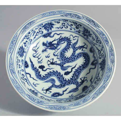 175 - A CHINESE BLUE AND WHITE PORCELAIN DRAGON AND LOTUS BOWL, 21cm diameter.