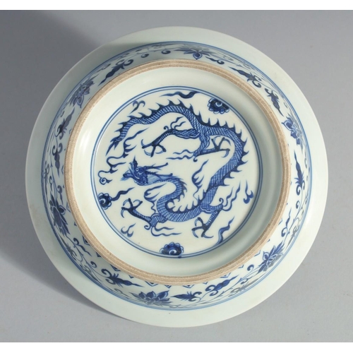 175 - A CHINESE BLUE AND WHITE PORCELAIN DRAGON AND LOTUS BOWL, 21cm diameter.