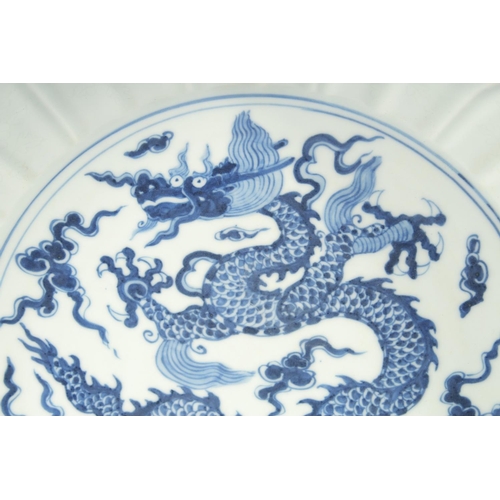 179 - A LARGE CHINESE BLUE AND WHITE PORCELAIN BOWL, with central panel depicting a dragon amongst stylise... 