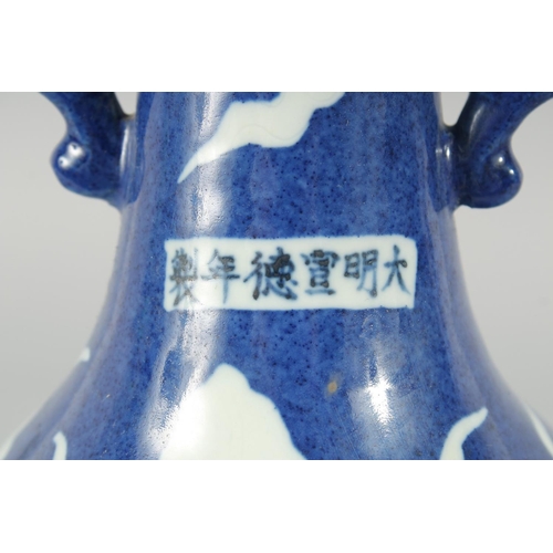 181 - A CHINESE SACRIFICIAL BLUE AND WHITE TWIN HANDLE DRAGON VASE, 29cm high.