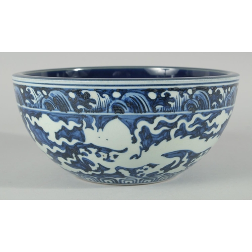 184 - A CHINESE SACRIFICIAL BLUE AND WHITE BOWL, decorated with dragons to the exterior, the base with six... 