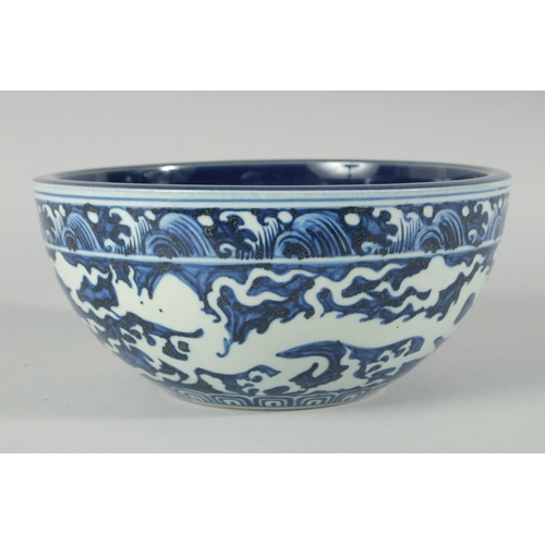 184 - A CHINESE SACRIFICIAL BLUE AND WHITE BOWL, decorated with dragons to the exterior, the base with six... 