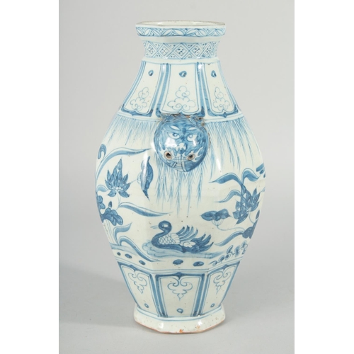 185 - A CHINESE OCTAGONAL BLUE AND WHITE TWIN HANDLE VASE, with moulded lion heads as handles, the body pa... 