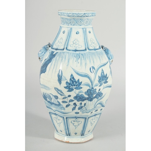 185 - A CHINESE OCTAGONAL BLUE AND WHITE TWIN HANDLE VASE, with moulded lion heads as handles, the body pa... 