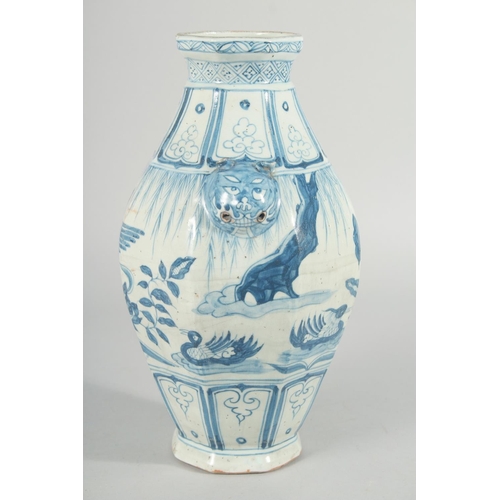 185 - A CHINESE OCTAGONAL BLUE AND WHITE TWIN HANDLE VASE, with moulded lion heads as handles, the body pa... 