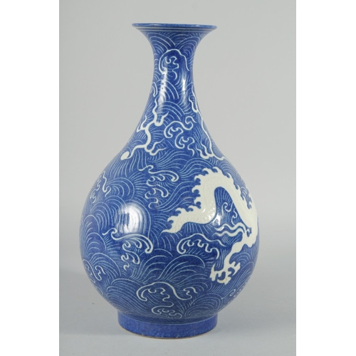 191 - A CHINESE BLUE GLAZE WAVE-PATTERN VASE, with carved dragon in white, carved inscription to the base,... 