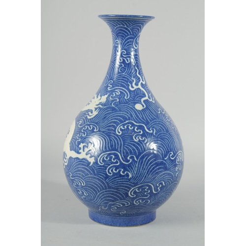 191 - A CHINESE BLUE GLAZE WAVE-PATTERN VASE, with carved dragon in white, carved inscription to the base,... 