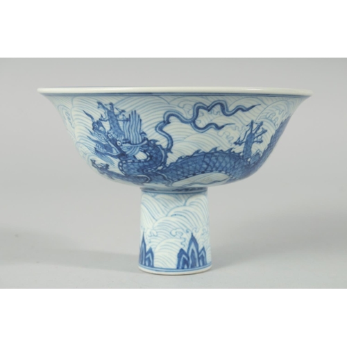 192 - A CHINESE BLUE AND WHITE PORCELAIN STEM CUP, decorated with dragons on a wave-pattern ground, interi... 