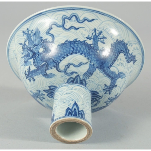 192 - A CHINESE BLUE AND WHITE PORCELAIN STEM CUP, decorated with dragons on a wave-pattern ground, interi... 