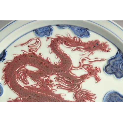 198 - A CHINESE BLUE AND UNDERGLAZE RED PORCELAIN DRAGON DISH, 30cm diameter.