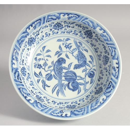 199 - A CHINESE BLUE AND WHITE PORCELAIN PEDESTAL BOWL, the interior centre painted with parrots on a bran... 