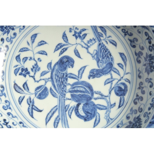 199 - A CHINESE BLUE AND WHITE PORCELAIN PEDESTAL BOWL, the interior centre painted with parrots on a bran... 