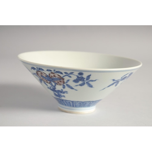 200 - A CHINESE BLUE, WHITE AND UNDERGLAZE RED PORCELAIN BOWL, painted with pomegranate, 16cm diameter.