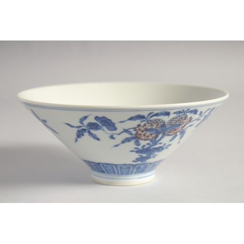 200 - A CHINESE BLUE, WHITE AND UNDERGLAZE RED PORCELAIN BOWL, painted with pomegranate, 16cm diameter.