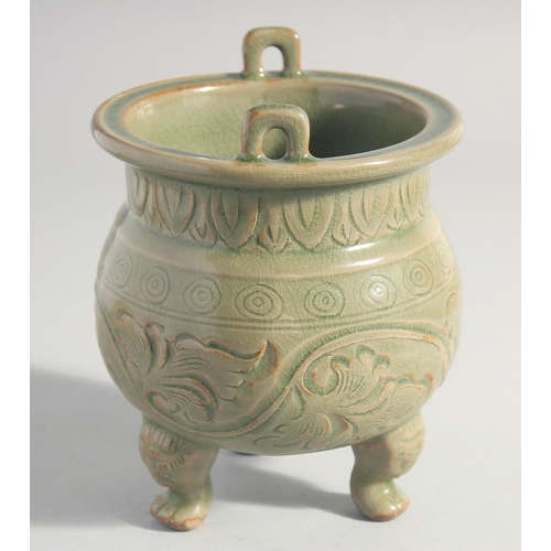 212 - A CHINESE LONGQUAN CELADON TRIPOD CENSER, with carved foliate decoration, 15.5cm high.