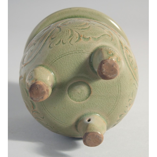 212 - A CHINESE LONGQUAN CELADON TRIPOD CENSER, with carved foliate decoration, 15.5cm high.