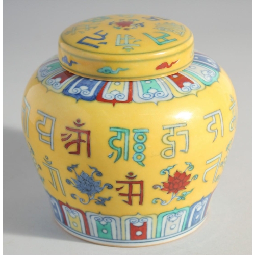 217 - A CHINESE YELLOW GROUND POLYCHROME GINGER JAR AND COVER, painted with characters, 13cm high.