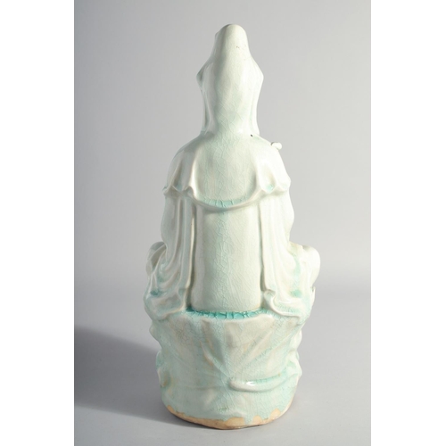 219 - A LARGE CHINESE YINGQING GLAZE QUANYIN seated upon a lotus throne, 45cm high.