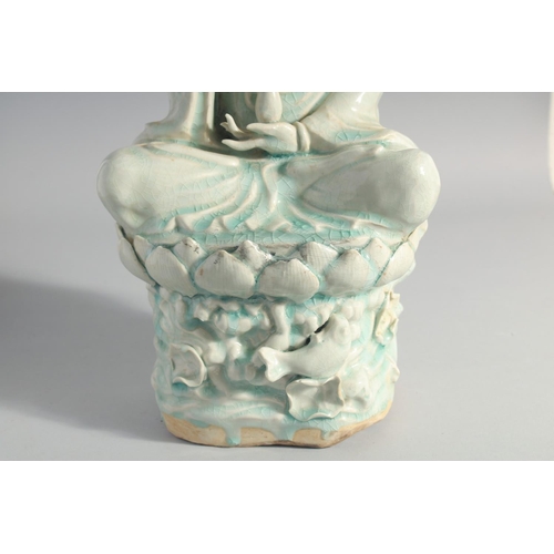 219 - A LARGE CHINESE YINGQING GLAZE QUANYIN seated upon a lotus throne, 45cm high.