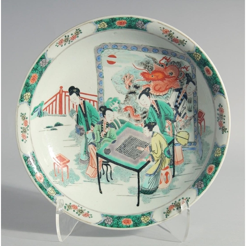 221 - A CHINESE FAMILLE VERTE PORCELAIN DISH, painted with female figures playing a board game with a drag... 