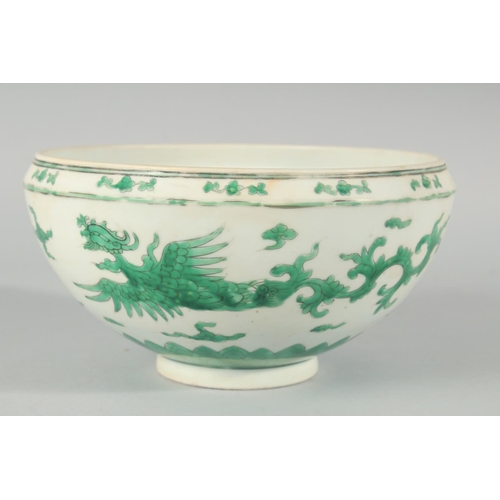 225 - A CHINESE GREEN ENAMELLED PORCELAIN BOWL, decorated with dragons and clouds, 24.5cm diameter.