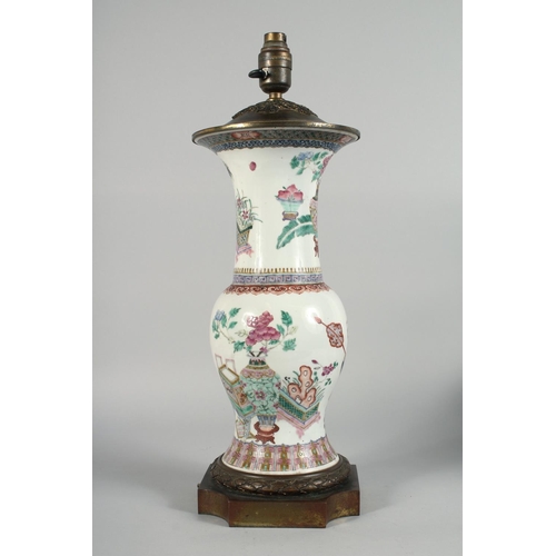 231 - A LARGE CHINESE FAMILLE ROSE PORCELAIN VASE LAMP, the body painted with potted flowers, vases and ja... 