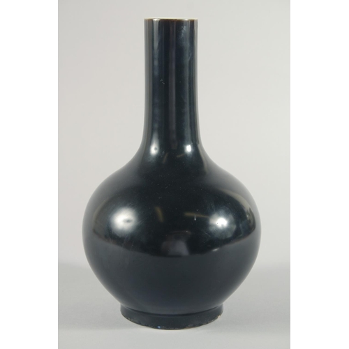 233 - A CHINESE FAMILLE NOIR PORCELAIN BOTTLE VASE, the base with six-character mark, 28.5cm high.