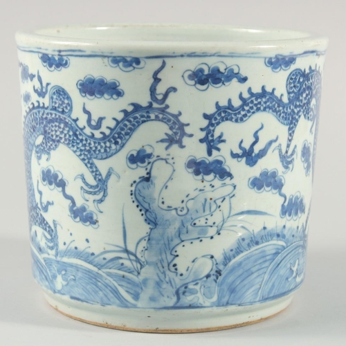 234 - A LARGE CHINESE BLUE AND WHITE PORCELAIN BRUSH POT, decorated with dragons above stylised waves incl... 