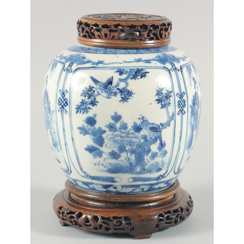 235 - A CHINESE BLUE AND WHITE PORCELAIN JAR, with a carved and pierced cover and stand, the jar painted w... 