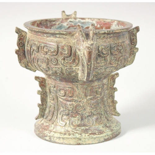 246 - A CHINESE ARCHAIC BRONZE TWIN HANDLE PEDESTAL CENSER, 20.5cm high, 30.5cm handle to handle.