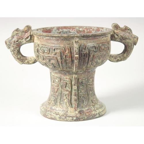 246 - A CHINESE ARCHAIC BRONZE TWIN HANDLE PEDESTAL CENSER, 20.5cm high, 30.5cm handle to handle.