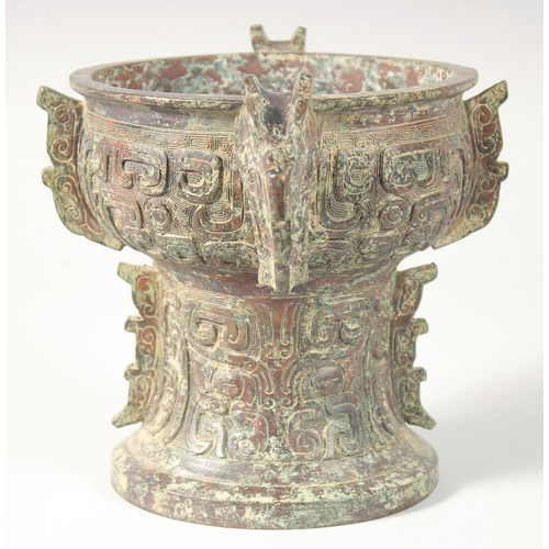 246 - A CHINESE ARCHAIC BRONZE TWIN HANDLE PEDESTAL CENSER, 20.5cm high, 30.5cm handle to handle.