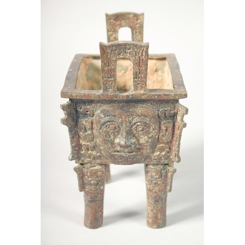 247 - AN UNUSUAL ARCHAIC BRONZE TWIN HANDLE CENSER, the rectangular form censer decorated with relief face... 