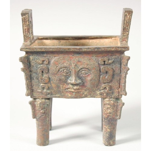 247 - AN UNUSUAL ARCHAIC BRONZE TWIN HANDLE CENSER, the rectangular form censer decorated with relief face... 