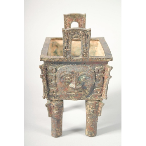 247 - AN UNUSUAL ARCHAIC BRONZE TWIN HANDLE CENSER, the rectangular form censer decorated with relief face... 