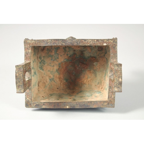 247 - AN UNUSUAL ARCHAIC BRONZE TWIN HANDLE CENSER, the rectangular form censer decorated with relief face... 