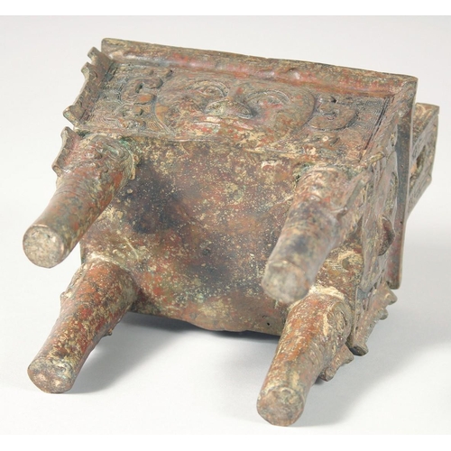 247 - AN UNUSUAL ARCHAIC BRONZE TWIN HANDLE CENSER, the rectangular form censer decorated with relief face... 