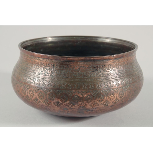 253 - A FINE LARGE 17TH CENTURY PERSIAN SAFAVID COPPER BOWL, engraved with a band of calligraphy and folia... 