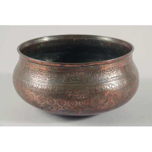 253 - A FINE LARGE 17TH CENTURY PERSIAN SAFAVID COPPER BOWL, engraved with a band of calligraphy and folia... 